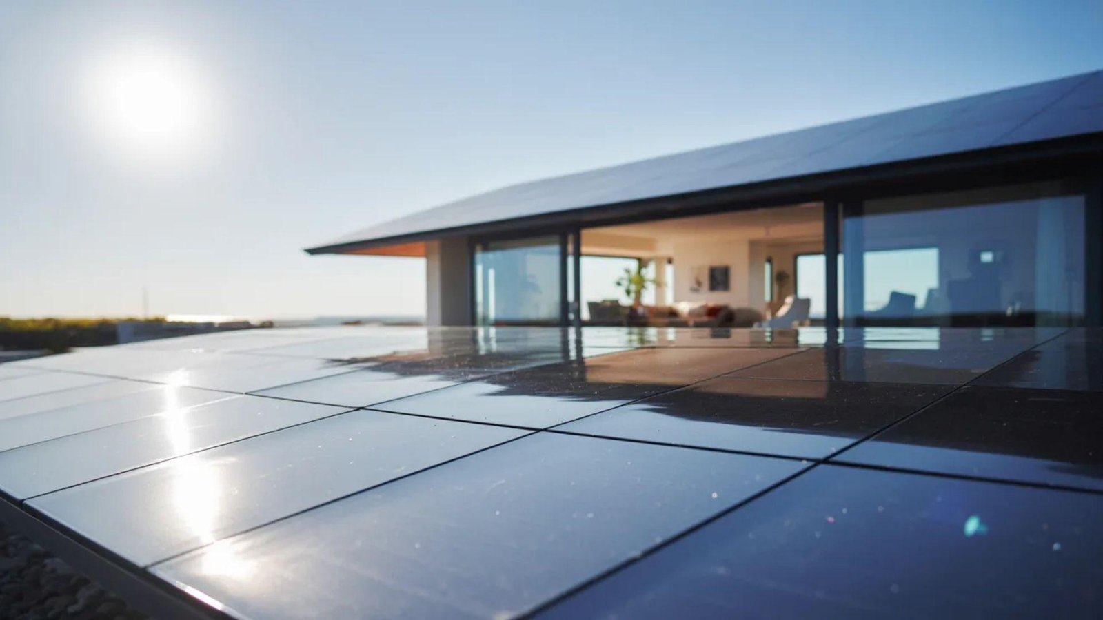 Solar panels installed on a house roof, basking in bright sunlight, showcasing renewable energy use.