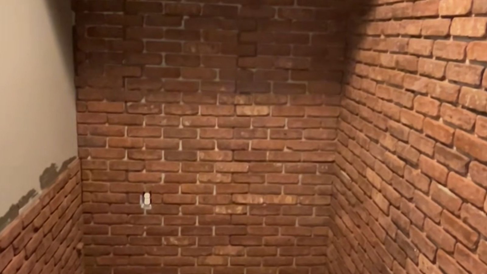 A shower installed within a brick wall, showcasing a unique architectural design.