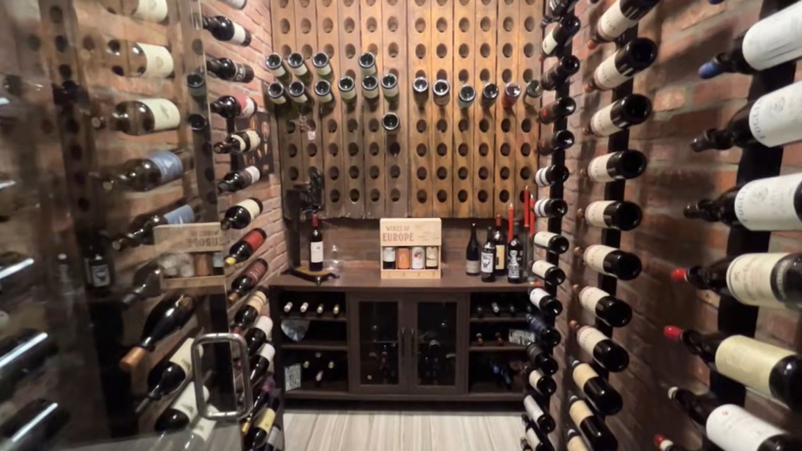 Step 7: Set Up Cooling System and Lighting A wine cellar filled with numerous bottles of wine arranged on wooden shelves.