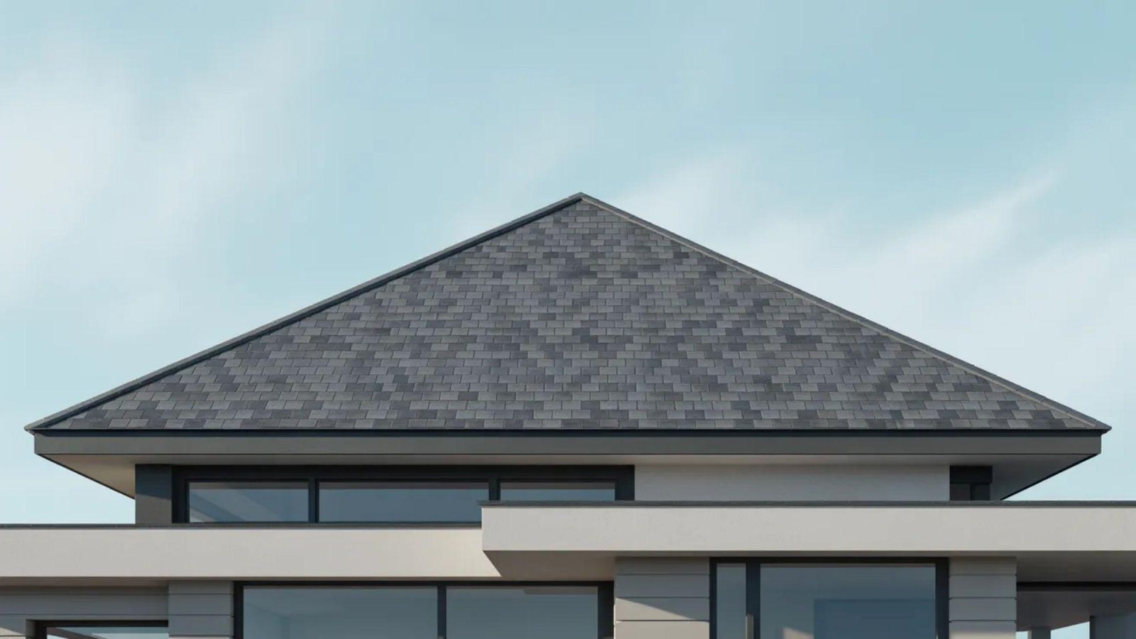 A modern house featuring a spacious, sloped roof and sleek architectural design.