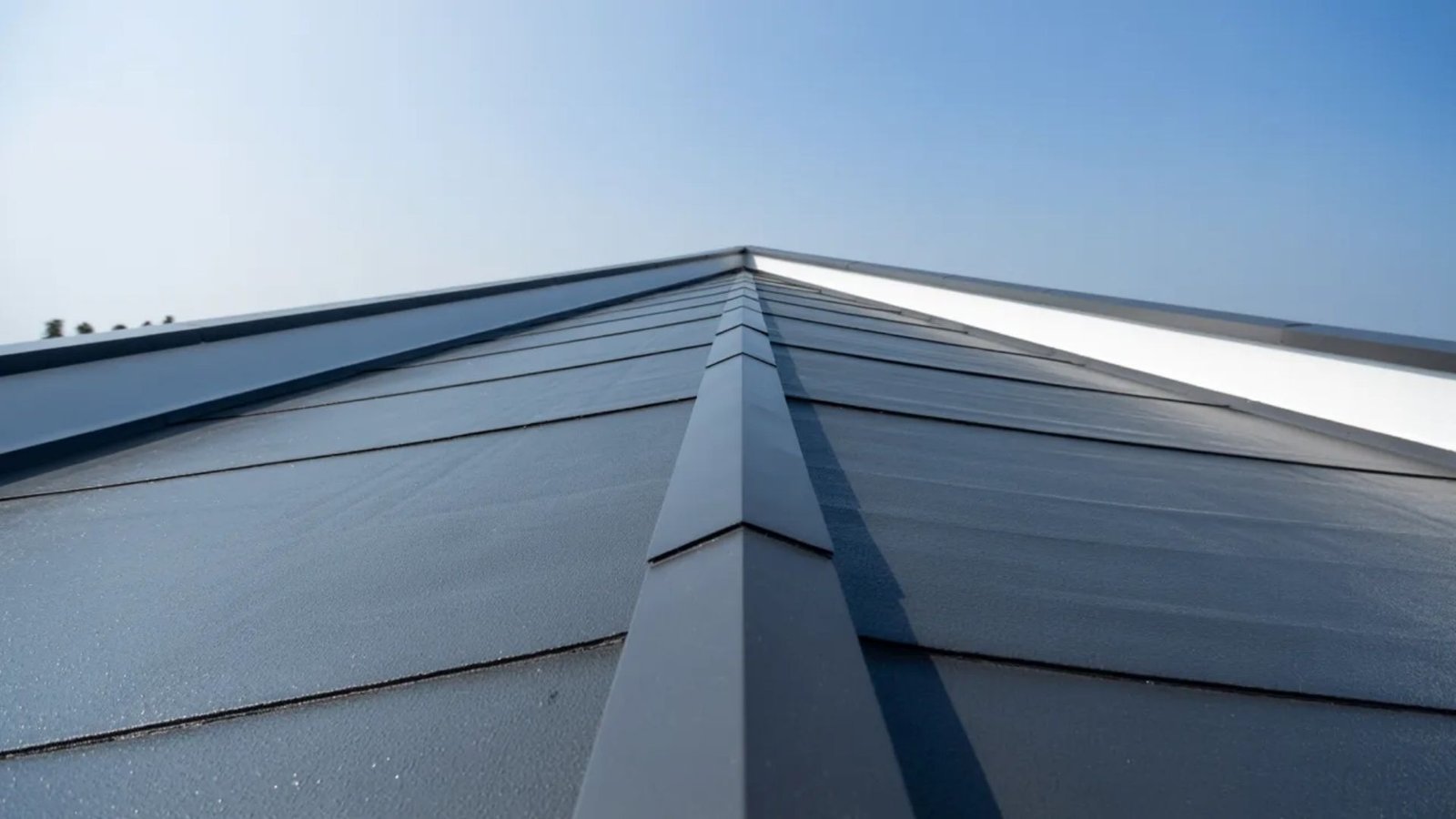 A close-up view of a roof featuring a sleek, modern metal roofing system.