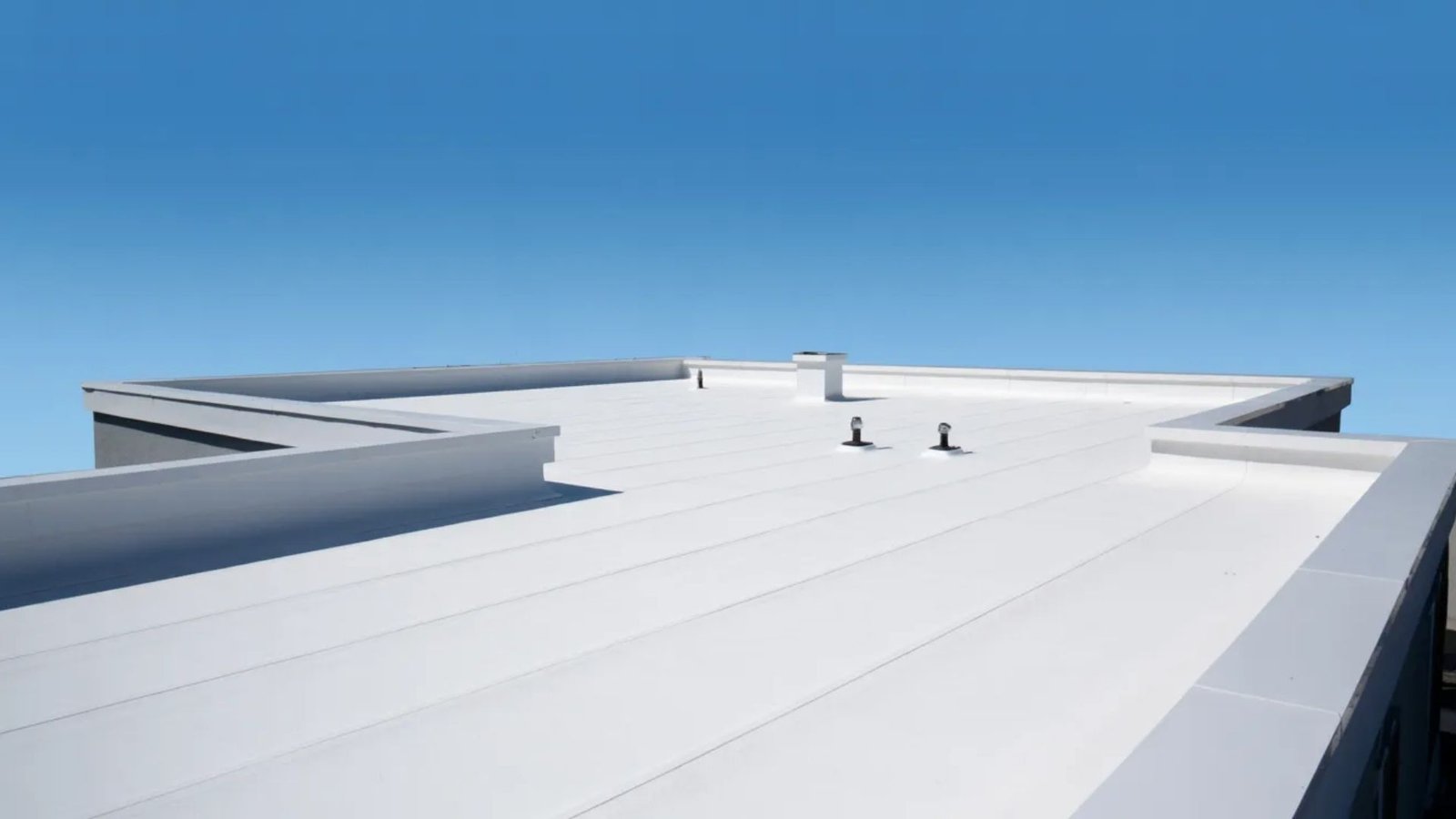 A roof featuring a clean, white surface, emphasizing its uniform color and design.