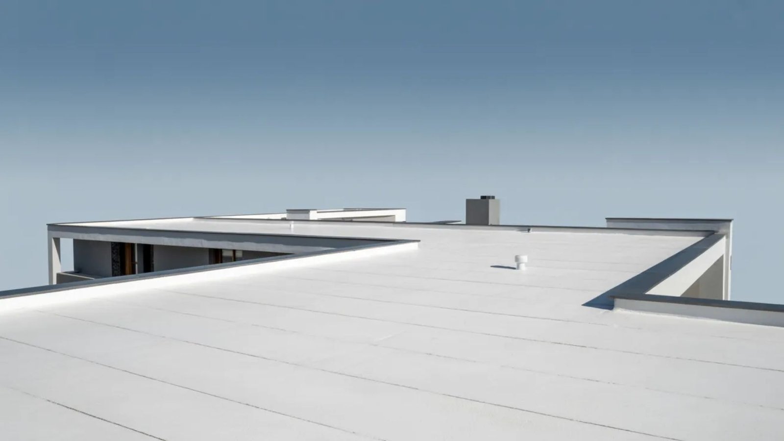 A roof featuring a clean, white surface, emphasizing its uniform color and design.