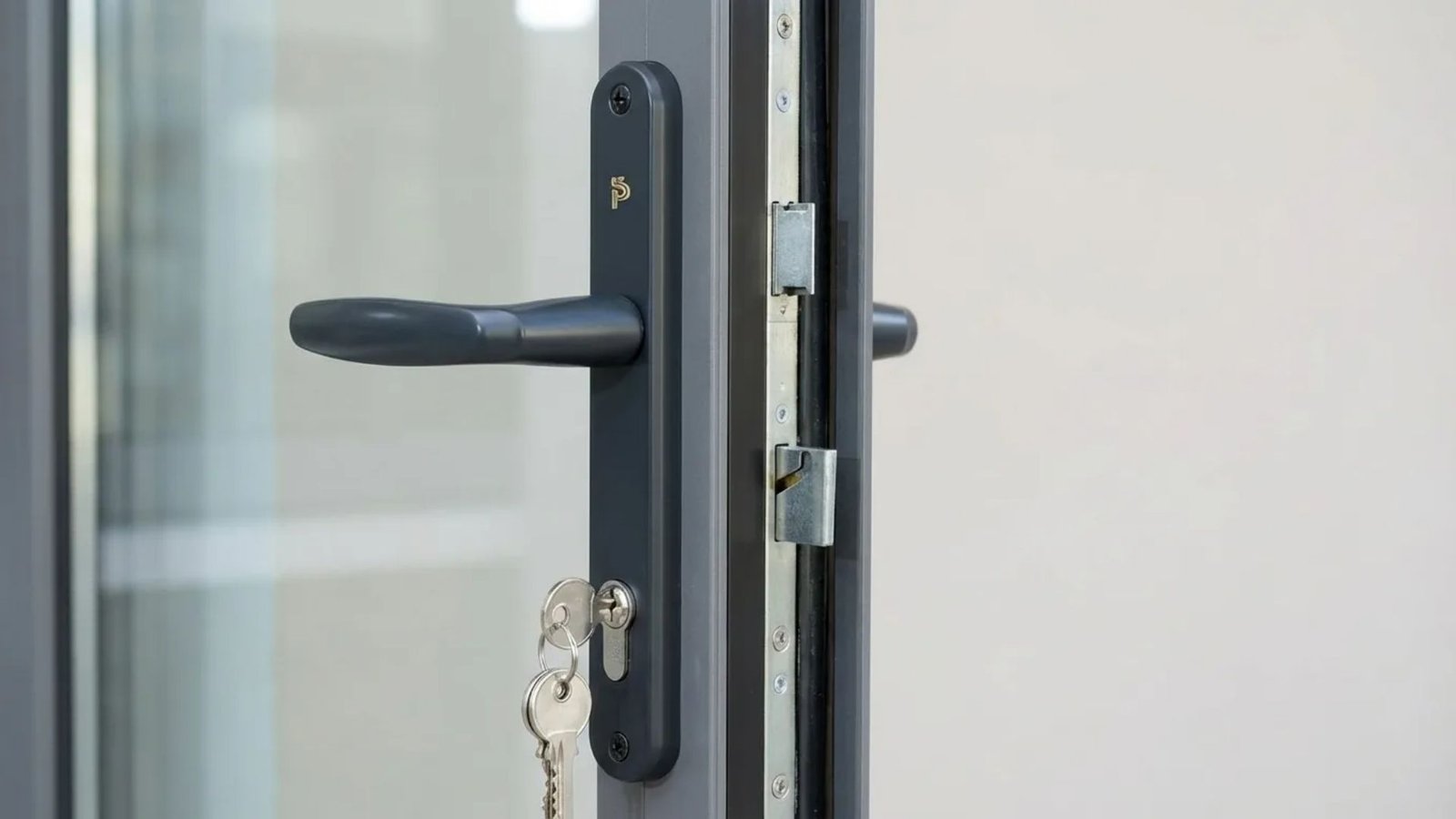 Close-up of a door handle featuring a key inserted into the lock, highlighting the mechanism and design details.